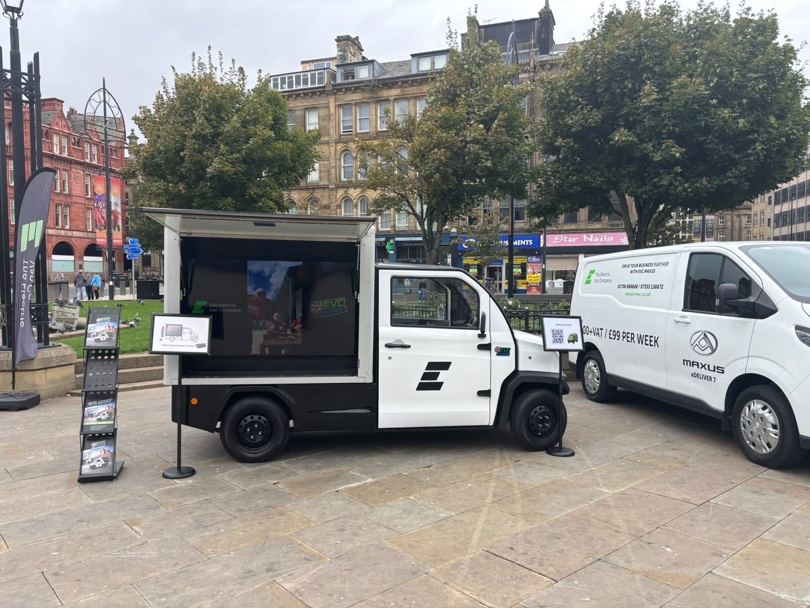 The Mobile Advertising Vehicle alongside the Maxus range