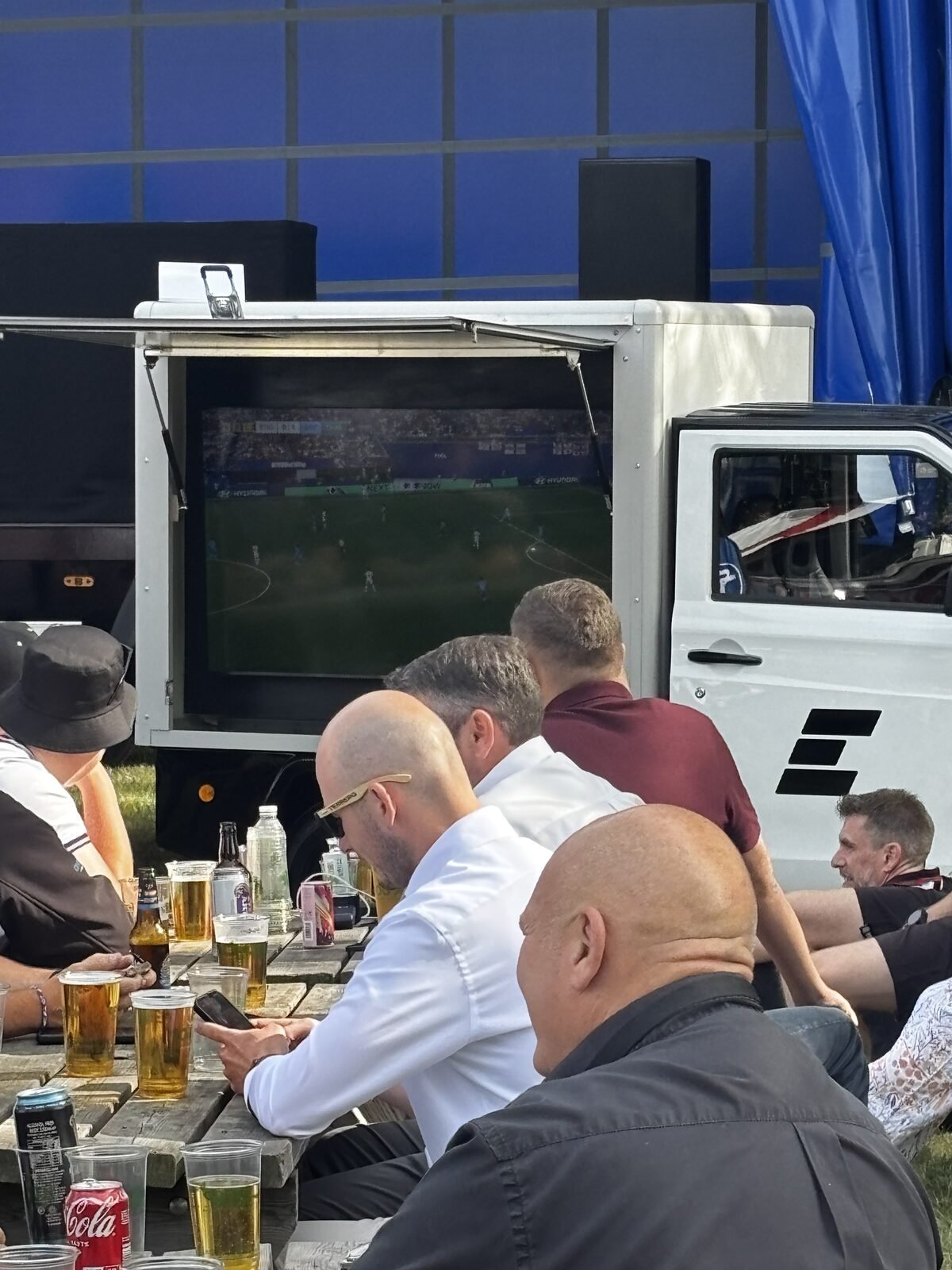Exhibitors watching the England game on our mobile screen vehicle after the show